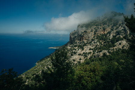 Aerial view of a mountain with a blue ocean background.