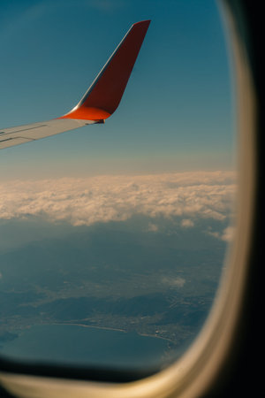 Aerial view through the clouds to the sea bay with coastal hills. Top view from the clouds to Japan...