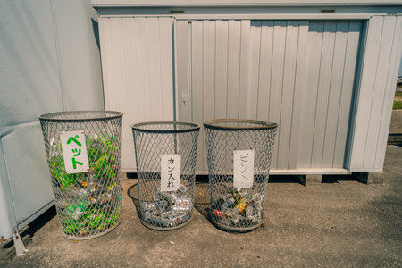 three containers of recycling reusing glass plastic and paper for sustainable waste management system. High quality photoの写真素材