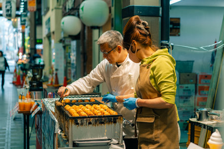 Osaka Japan - may 2 2025 Process to Cooking Takoyaki on hot pan Famous food, street food. High quality photoの写真素材