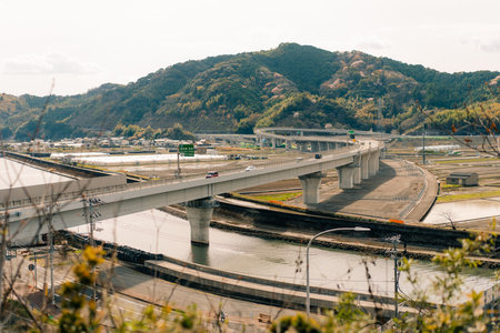 a bridge complex passing over a body of water and intersecting with other roads. High quality photoの写真素材