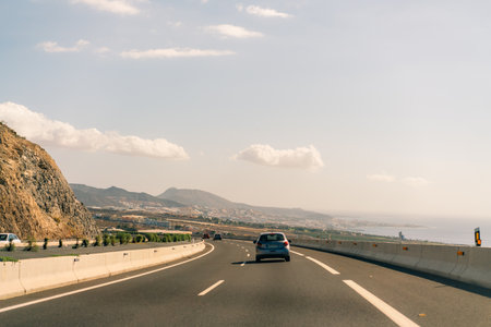 marking different lanes, on the dark asphalt floor of a highway. Tenerife, Canary Islands, Spain. High quality photoのeditorial素材