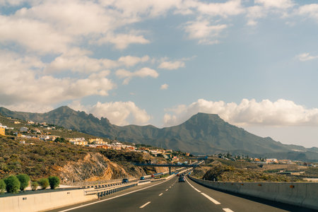marking different lanes, on the dark asphalt floor of a highway. Tenerife, Canary Islands, Spain. High quality photoのeditorial素材