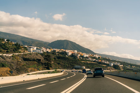 marking different lanes, on the dark asphalt floor of a highway. Tenerife, Canary Islands, Spain. High quality photoのeditorial素材