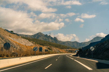 marking different lanes, on the dark asphalt floor of a highway. Tenerife, Canary Islands, Spain....