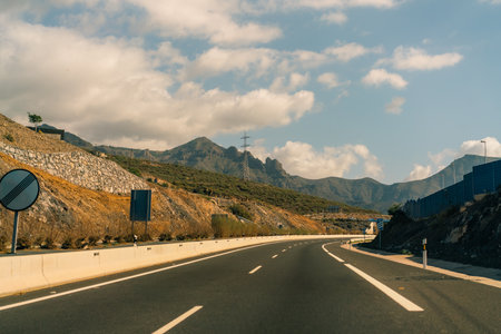 marking different lanes, on the dark asphalt floor of a highway. Tenerife, Canary Islands, Spain. High quality photoのeditorial素材