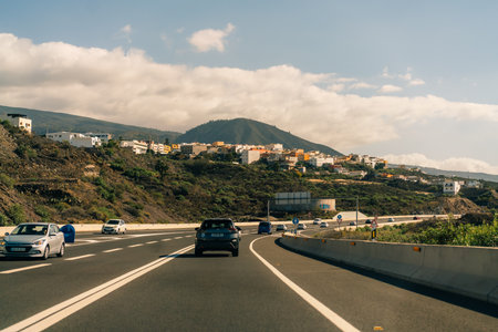 marking different lanes, on the dark asphalt floor of a highway. Tenerife, Canary Islands, Spain. High quality photoのeditorial素材