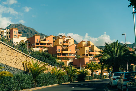 View of palm trees, and beautiful buildings of Spanish architecture, in La Caleta, Tenerife, Spain - 3 Dec 2025. High quality photoのeditorial素材