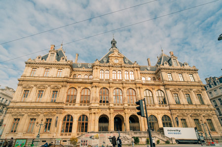 Hyperlapse of Palais de la Bourse Palais du Commerce front view in the Les Cordeliers quarter, Lyon, France. A historic 19th-century building with traffic passing on the streetのeditorial素材