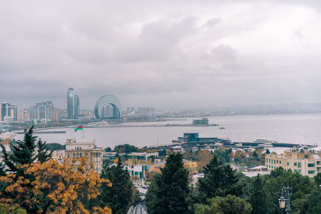 Baku, Azerbaijan - Dec 1 2025 The Crescent Development Project features distinct modern architecture, including the Crescent Hotel, set against a beautiful cloudy sky on the Caspian Sea coastの写真素材