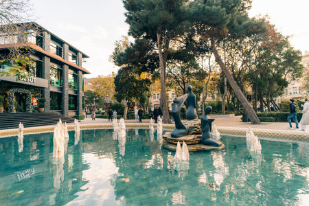 Baku, Azerbaijan - Dec 1 2025 View of the Molokan Gardens in downtown Baku. The central pond features three nymphs among a collection of stalagmites. High quality photoのeditorial素材
