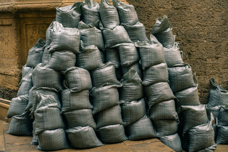 Bags with building materials - sand and gravel, arranged in a row. High quality photoの写真素材