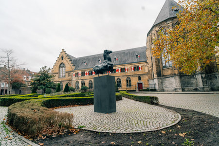 MAASTRICHT, NETHERLANDS - SEP 8, 2025: Building of Kruisherenhotel viewed from Kommel street. The hotel housed in the restored Gothic monastery and provide luxury serviceの写真素材