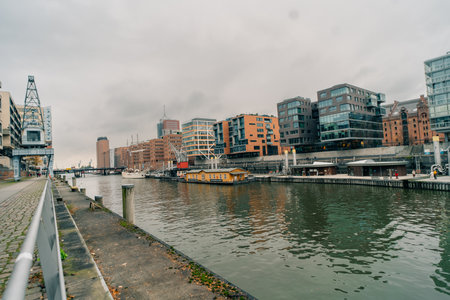 Hamburg, Germany - 1 Oct 2025 - A modern waterfront scene featuring contemporary buildings along a...