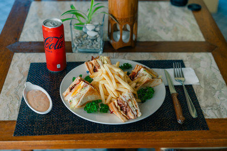 club sandwich with French fries and a drink. Los Angeles, USA - October 1, 2025. High quality photoのeditorial素材