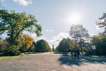 Castle in the park of the Sudfriedhof Leipzig in the evening sun and with reflection on a gravestone. Leipzig, germany - 2 nov 2025. High quality photoのeditorial素材