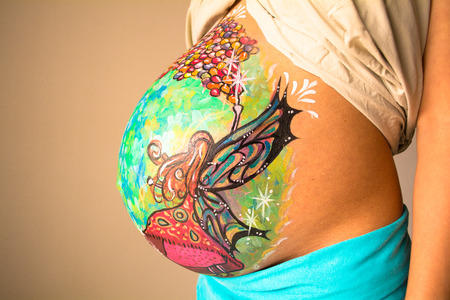 Colorful belly painting of a pregnant womanの写真素材