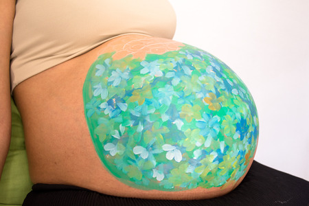 Colorful belly painting of a pregnant womanの写真素材