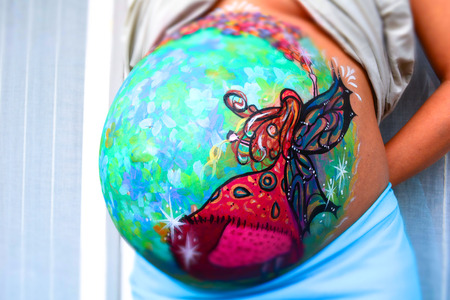 Colorful belly painting of a pregnant womanの写真素材