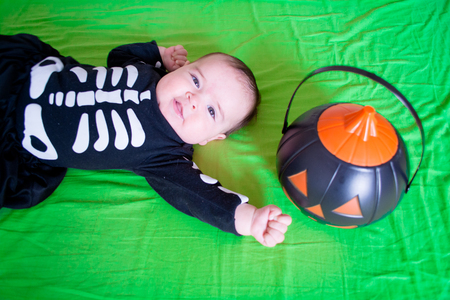 Baby under four months old dressed for Halloweenの写真素材