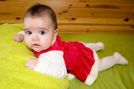 Baby under four months old dressed for Christmasの写真素材