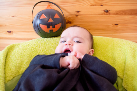 Baby under four months old dressed for Halloweenの写真素材