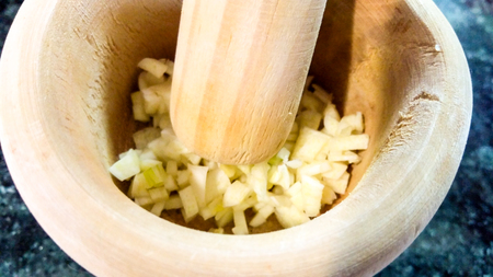 Crushing garlic with a mortarの写真素材