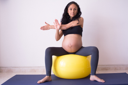 Pregnant woman doing excercise with a pilates ballの写真素材