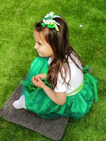 Four year old girl celebrating Saint Patricks Day dressed up in greenの写真素材