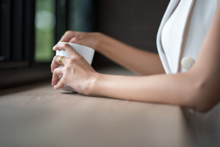 close up of woman hands holding cup of coffeeの写真素材