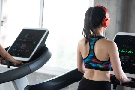 Asian woman on treadmill in the gym