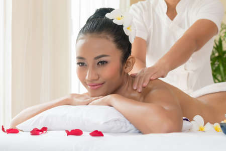 Beautiful young woman getting spa massageの写真素材