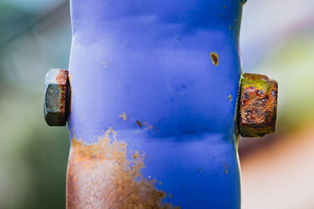 Rusty in bolt and nut and blue metal pipe, Using part in outdoor, Selective focusの写真素材
