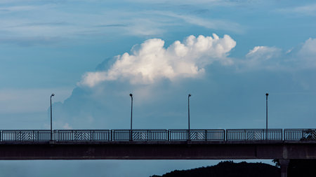 Beautiful view of white clouds above the bridge for walking across the railroad with LED lighting.の写真素材
