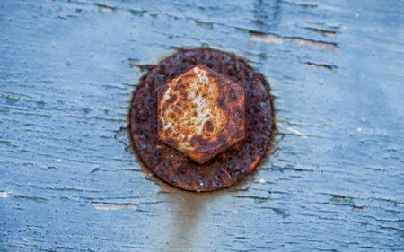 Close up of rusty round bolt and washer on weathered wooden.の写真素材