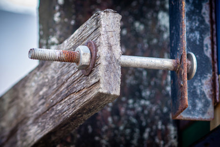 Rusty on nut, bolt and washer for attached to the old wooden plate long time.の写真素材