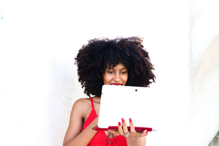 beautiful afro-american woman sitting with her laptop in a park. The photo is taken from above and you can see the girl below. Concept college studentの写真素材