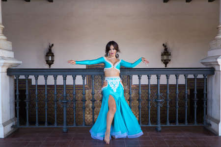 beautiful young belly dancer is posing for the camera in a photo shoot. The woman is beautiful and dressed in traditional clothes. Beauty, folklore and belly dance concept.の写真素材
