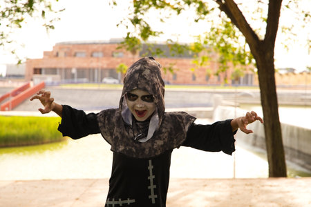 Happy halloween. Child in costume for the halloween party. The boy is scaring people. Trick or treat.の写真素材
