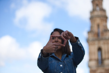 Woman's hands frame a distant view over the horizon. Woman making a frame around the view with her hands, future planning concept. Concept of planning and vision for new yearの写真素材