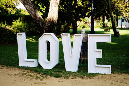 White wooden love letters on the lawn in the decoration for an outdoor weddingの写真素材