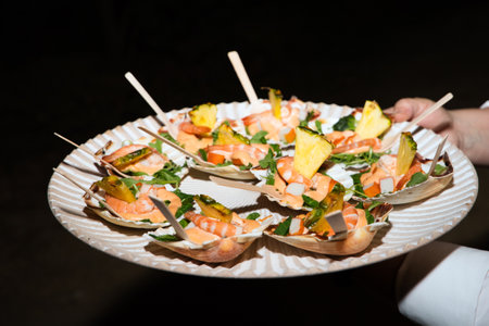 Canape of different flavors, fish, seafood, ham, meat, vegetables ready to serve in a catering serviceの写真素材