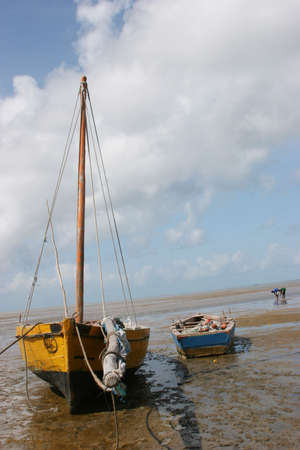A boat stranded on the beach during low-tide in Bazaruto