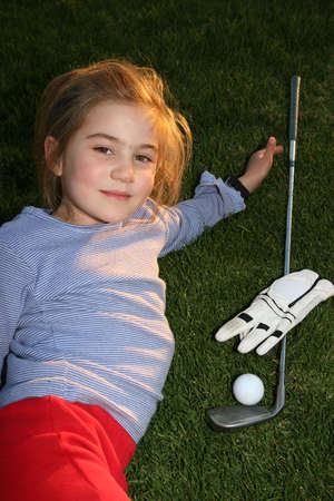 Young girl with golgclub, glove and ballの写真素材