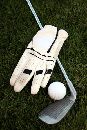 Golf kit : Ball, glove, club and green grassの写真素材
