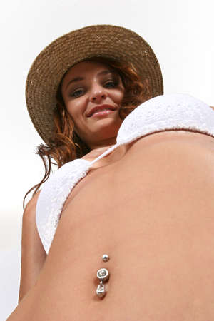 Woman sitting in bikini with shoes onの写真素材