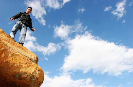 Man standing on top of rockの写真素材