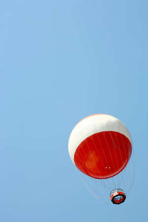 White and Red balloon in the skyの写真素材
