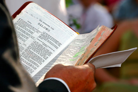Priest reading from the bible