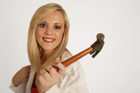A woman holding a hammer in her handの写真素材